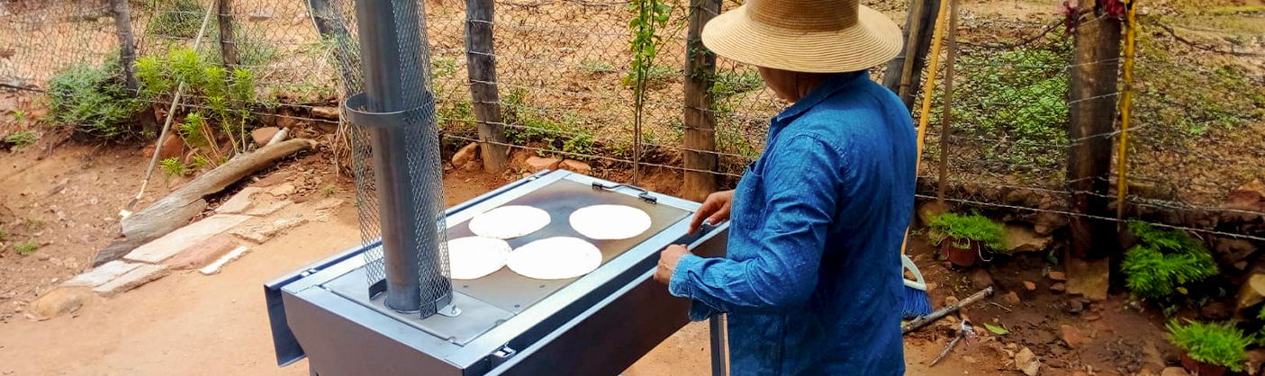A man using a cookstove provided by the Sempra Foundation