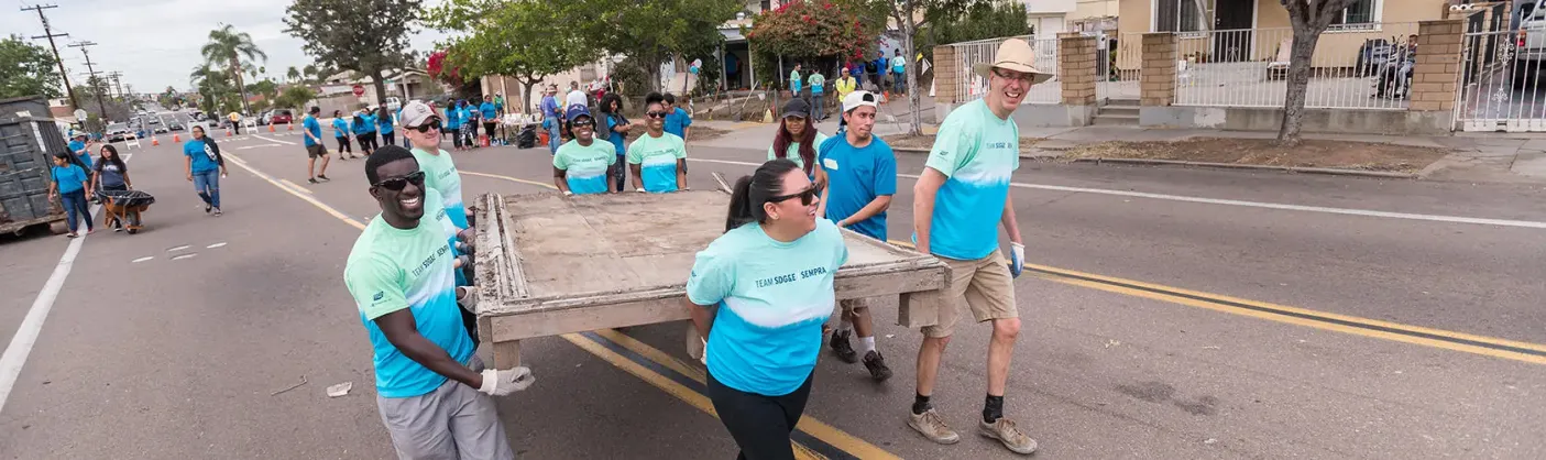Employees volunteering at a community cleanup