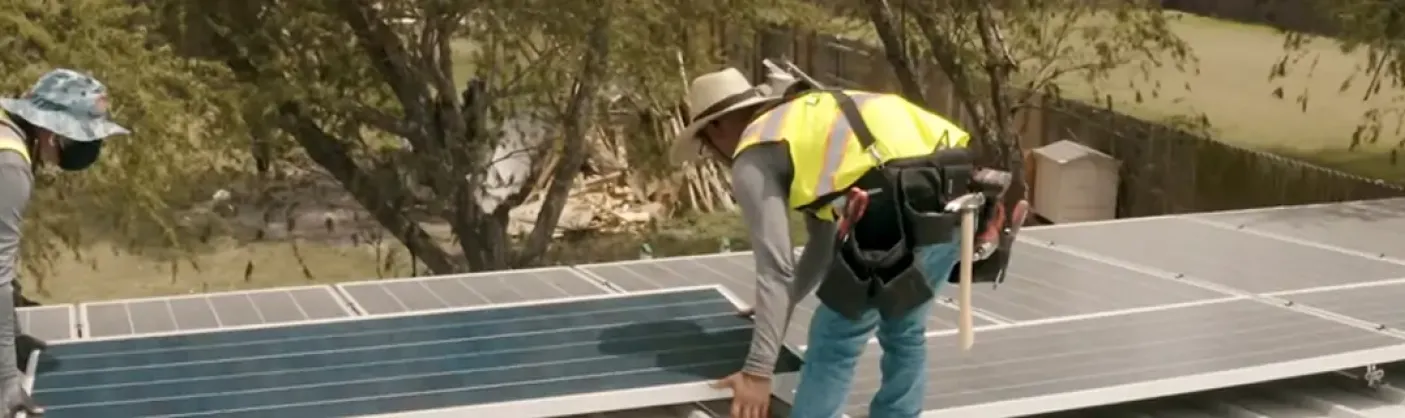 Team members install solar panels