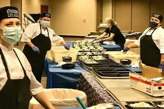 people preparing and distributing food during the COVID-19 pandemic