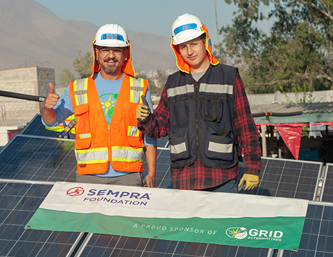 Sempra Foundation volunteers posing with solar panels