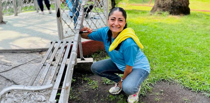 An employee volunteers at a community beautification project