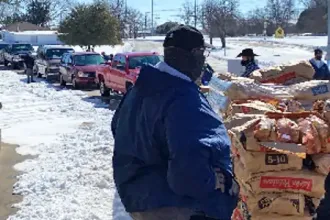 People line up to receive food and supplies during the winter freeze in Texas in 2021